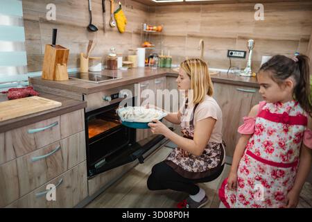 Mutter und Tochter kochen zusammen in einer gemütlichen Küche zu Hause Stockfoto