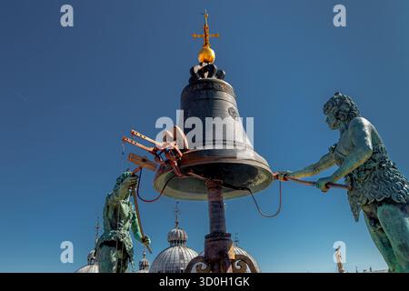 Zwei Bronzestatuen, bekannt als die Mauren, schlagen die Glocke auf dem Torre dell'Orologio oder dem Uhrturm auf dem Markusplatz in Venedig, Italien Stockfoto