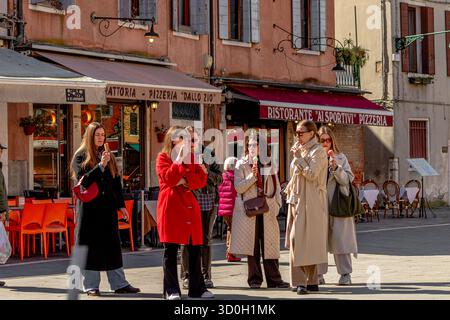 Eine Gruppe italienischer Frauen, die zusammen im Campo SATA Margherita im Dorsoduro Sestiere von Venedig, Italien, Eis essen Stockfoto