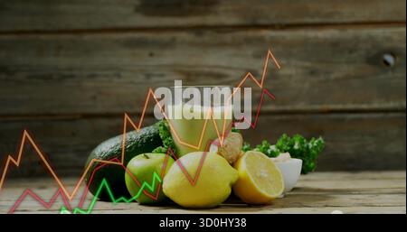 Mit Avocado, Apfel, Zitrone, Ingwer, Grünkohl, Nussschale, grüner Smoothie auf dem Tisch, der Trends zeigt Stockfoto