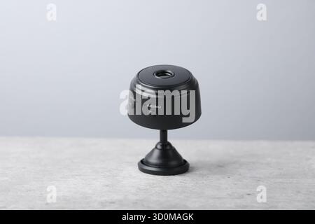 Moderne, versteckte Spionageskamera auf hellgrauem Tisch, Nahaufnahme Stockfoto