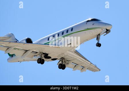 Palm Springs, Kalifornien, USA. Oktober 2025. Ein weißer Business-Jet mit grünen Akzentstreifen ''" A Bombardier BD''''''100'''1A10 Challenger 300 Registered C-FRGY ''''''" fährt in Richtung Palm Springs International Airport (PSP) in Kalifornien ab. Das Flugzeug ist in Landekonfiguration (Gang unten, Klappen ausgelöst) gegen einen klaren, wüstenblauen Himmel im Coachella Valley zu sehen. Laut seiner Registrierung ist C-FRGY ein privates Unternehmensflugzeug (Credit Image: © Ian L. Sitren/ZUMA Press Wire), DAS NUR REDAKTIONELL GENUTZT WIRD! Nicht für kommerzielle ZWECKE! Stockfoto