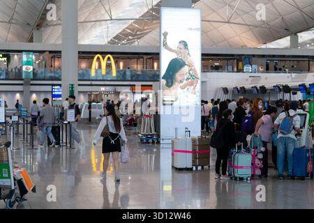 Hongkong, China - 20. September 2025: Personen werden am Check-in-Bereich des internationalen Flughafens von Hongkong gesehen. Stockfoto