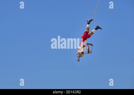 Crisanto Méndez Jiménez spielt Flöte und Trommel, während er und drei andere Voladores in Chapala, Mexiko, auf die Erde herabsteigen. Stockfoto