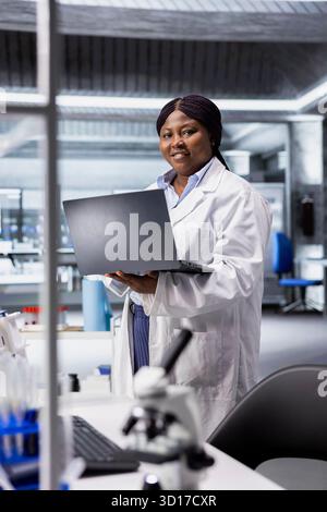 Porträt eines Laborwissenschaftlers arbeitet in Biochemie und Genetik mit einem Laptop und führt Experimente mit modernen Werkzeugen und Geräten durch. Biotechnologische Forschung für Medizin und Molekularwissenschaften. Stockfoto