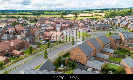 Aus der Vogelperspektive der Wohnsiedlung Cotchett Village in Mickleover, Derby, mit neuen Häusern und umliegendem Ackerland. Stockfoto
