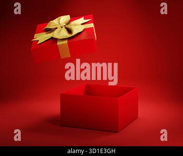 Offene Geschenkbox mit goldenem Band auf rotem Hintergrund. Weihnachtsgeschenk Shopping Sale Überraschung. Stockfoto