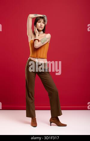 Eine junge, schöne Frau zeigt ihren einzigartigen Sinn für Mode mit Selbstvertrauen und Anmut. Stockfoto