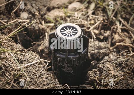 Sprinkler im Boden. Ich habe gerade ein Bewässerungssystem mit Makroaufnahme installiert Stockfoto