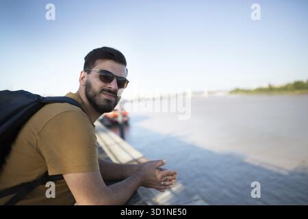 Schöner Schwarzbärtiger als Tourist, der die Stadt erkundet. Porträt eines schönen europäischen Mannes Stockfoto