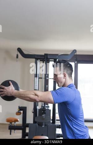 Starker Bodybuilder-Mann mit perfekten bauchmuskeln, Schultern, Bizeps, Trizeps und Brust, der seine Muskeln beugt Stockfoto
