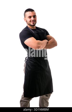 Porträt eines gutaussehenden Küchenchefs in schwarzer Schürze Stockfoto