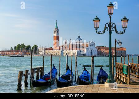 Gondeln liegen in der Nähe des Markusplatzes gegenüber der Insel San Giorgio Maggiore in Venedig, Italien Stockfoto