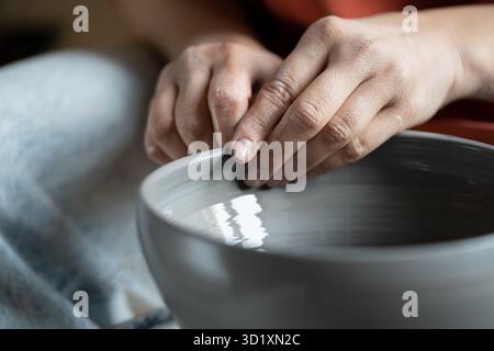 Stresslindernde Hobbys, weibliche Hände Formen nassen Lehm am Rad Stockfoto