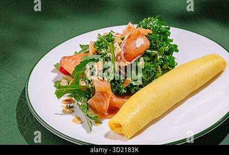 Köstliches Omelette serviert mit frischem Salat mit Grünkohl und geräuchertem Lachs in einer gemütlichen Atmosphäre Stockfoto