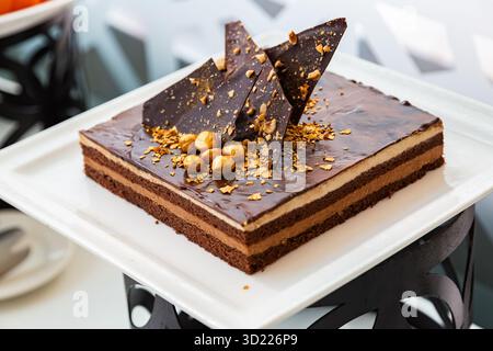 Haselnusskuchen aus dunkler Schokolade mit Haselnusscreme und Schokoladenganache Stockfoto