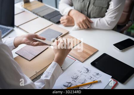 Innenarchitektin präsentiert umweltfreundliche Holzmaterialmuster für nachhaltige Wohnkultur Stockfoto