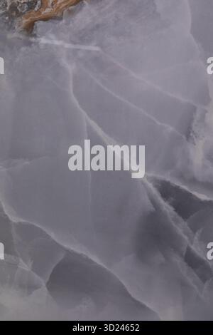 Schöne abstrakte Nahaufnahme eines durchscheinenden grauen Steins mit komplizierten Mustern und Texturen Stockfoto
