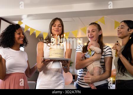Geburtstagsfeier, bunte Freunde genießen Kuchen und Lachen auf der Heimfeier. Feier, Glück, Freundschaft, Freude, Zweisamkeit || Model veröffentlicht Stockfoto