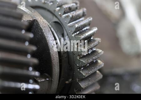 Nahaufnahme von verschlissenen Metallrädern mit komplizierten Zähnen und Anzeichen von mechanischer Anwendung und Reibung, die ein Gefühl für industrielle Prozesse und Maschinen wecken Stockfoto