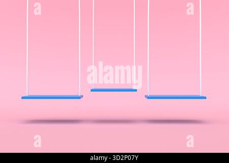Drei leere blaue Schaukeln mit weißen Seilen, die auf einem sanften rosa Hintergrund hängen. Minimalistisches Kindheits- und Familienkonzept Stockfoto