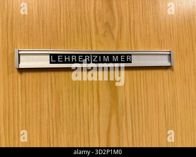 Nahaufnahme eines alten Lehrerbüros im deutschen Lehrerzimmer-Schild an einer hölzernen Schultür. Symbol für Bildung, Autorität, Lernumgebung und die Stockfoto