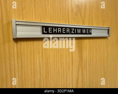 Nahaufnahme eines alten Lehrerbüros im deutschen Lehrerzimmer-Schild an einer hölzernen Schultür. Symbol für Bildung, Autorität, Lernumgebung und die Stockfoto