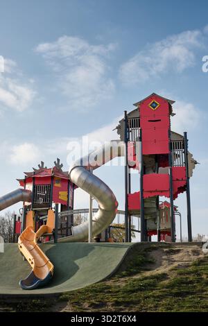 Moderner Spielplatz im Freien mit großen Türmen, Tunneln und Rutschen in einem urbanen Park in Lodz, Polen, der für die Erholung der Kinder und die Freizeit der Familie konzipiert ist. Stockfoto