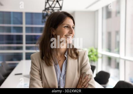 Fröhliche junge weibliche Führungskraft posiert im Amt Stockfoto