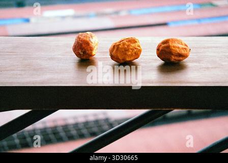 Drei getrocknete Zitronen liegen auf einem Holzbrett, in warmen analogen Tönen mit rustikalem, strukturiertem Stillleben. Stockfoto