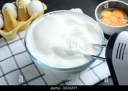 Eiweiß mit Handrührgerät am Tisch, Nahaufnahme Stockfoto