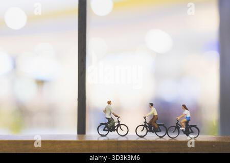 Miniatur-Leute : Reisende mit Fahrrad auf Holzbrücke Stockfoto