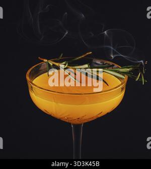 Essen, Rosmarin-Cocktail - goldener Rum, Rosmarin, Fruchtsaft und Sirup Stockfoto