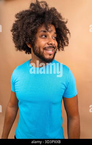 Der junge Schwarze lächelt und blickt weg Stockfoto