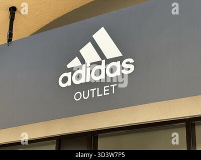 Belgrad, Serbien - 16. Juni 2024: Außenbeschilderung der Ladenfront von Adidas Outlet mit dem berühmten Logo und Branding in drei Streifen Stockfoto
