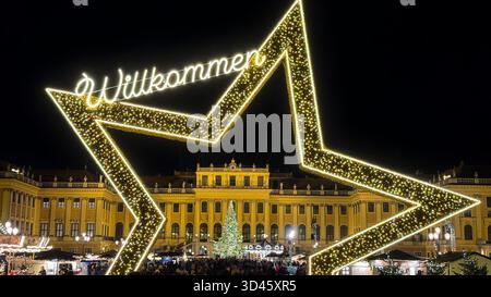 04.12.2024 Wien: Festlicher Weihnachtsmarkt im Schloss Schönbrunn in Wien, Österreich, mit großem beleuchtetem Stern, Weihnachtsbaum und Feiertag Stockfoto