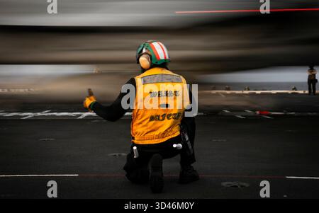 Die 1. Klasse Spencer Taylor, die dem Air Department an Bord des weltweit größten Flugzeugträgers, USS Gerald R. Ford (CVN 78), zugewiesen wurde, signalisiert den Start einer F/A-18E Super Hornet, die an die Strike Fighter Squadron 87 angeschlossen ist, von einem der Bugkatapulte des Schiffes am 5. November 2025. Gerald R. Ford, ein erstklassiger Nuklearflugzeugträger der Carrier Strike Group 12, befindet sich im Einsatzgebiet der 6. US-Flotte, um die Wirksamkeit, die Letalität und die Bereitschaft der US-Marinestreitkräfte Europa-Afrika zu unterstützen und die USA zu verteidigen Stockfoto
