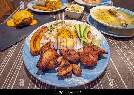 Eine Schüssel mit grüner Kochbananenkugelsuppe zeigt große grüne Kochbananenknödel gefüllt mit Fleisch, in einer Erdnussbrühe mit Yucca und Gemüse. Stockfoto