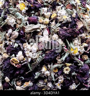 Istanbul, Turkiye - 8. November 2025: Nahaufnahme einer blumigen Kräutertee-Mischung mit getrockneten Kamillen und Hibiskusblüten auf dem Gewürzbasar. Stockfoto
