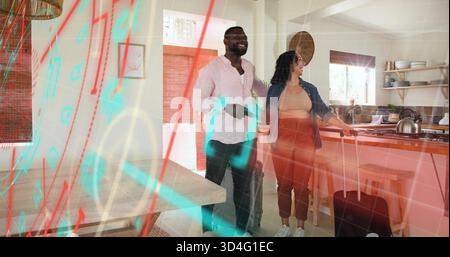 Ein stehendes Paar lächelnd, hält Rollenkoffer in der Nähe einer hölzernen Kücheninsel und trägt eine Jeansjacke Stockfoto