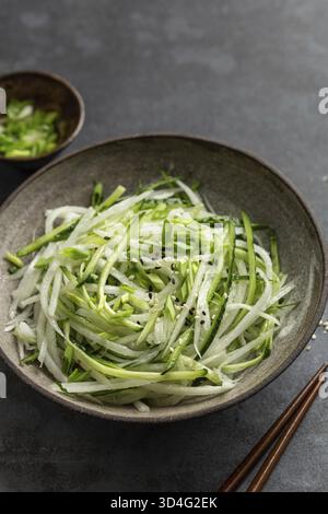 Essen, frische Gurken und Daikon Rettich Salat in Schüssel, gesunde vegane Rohkost Stockfoto
