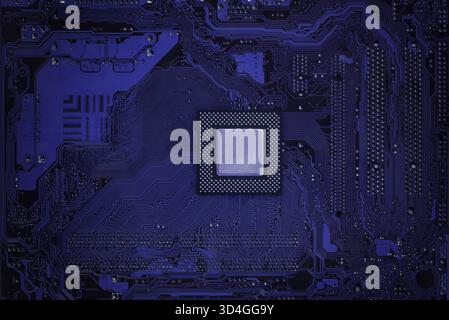 Nahaufnahme eines violetten Computermotherboards mit zentralem Prozessorchip mit detaillierten Schaltungsspuren und moderner Technologie für Digitaltechnik Stockfoto