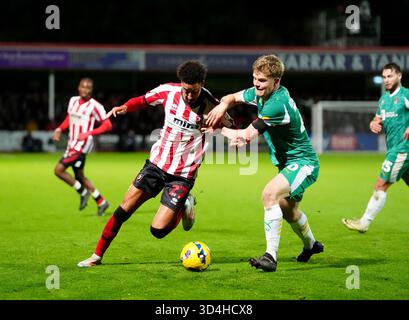 Scott Robertson von Notts County (rechts) und Jonathan Tomkinson von Cheltenham Town (links) kämpfen um den Ball während des Spiels der Sky Bet League Two im EV Charger Points Stadium in Cheltenham 2025. Stockfoto