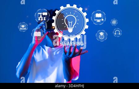 Eine dynamische Szene, in der ein junger Mensch in digitales Lernen eingetaucht ist und die transformative Kraft von E-Learning-Tools und modernen Technologien unterstreicht Stockfoto