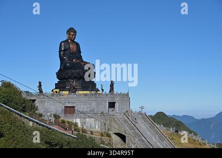 Große Amitabha Buddha Statue in der Nähe des Gipfels im Sun World Fansipan Legend Touristenkomplex, umgeben von Dharmaphalas oder Dharma Beschützern Stockfoto