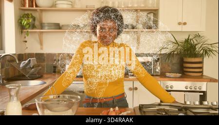 Frau in Senftop und Jeans in Glasschale in Küche mit Neuralüberlagerung vorbereiten Stockfoto