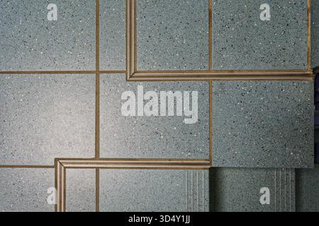 Detailed view of blue ceramic floor tiles with clean expansion joints and metal profiles showing precision in modern interior construction and craftsm Stockfoto