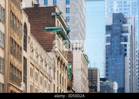 Mischung aus historischer und moderner Architektur in der Innenstadt von Montreal mit alten Steinfassaden und zeitgenössischen Glashochhäusern Stockfoto