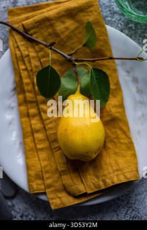 Close-up Overhead-Ansicht eines rustikalen Herbstplatzes auf einem Tisch mit reifer Birne Stockfoto
