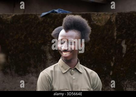 Gasura Ruanda - 8. September 2025; afrikanischer ruandischer Mann mit großem Lächeln und einzigartiger Frisur, bekannt als Amasunzu, symbolisierte traditionell den Adel, Stockfoto
